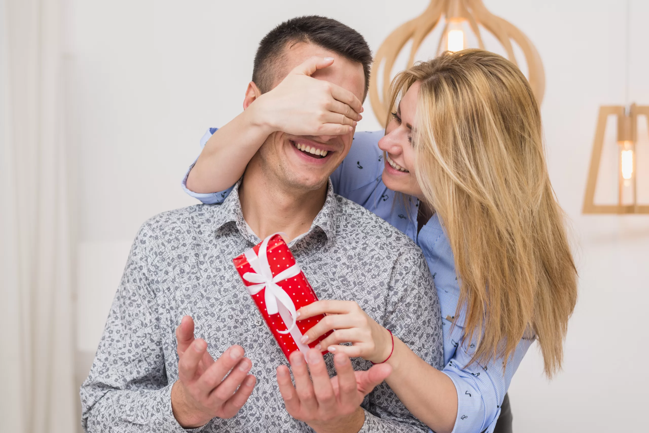 happy-lady-with-present-closing-eyes-smiling-guy